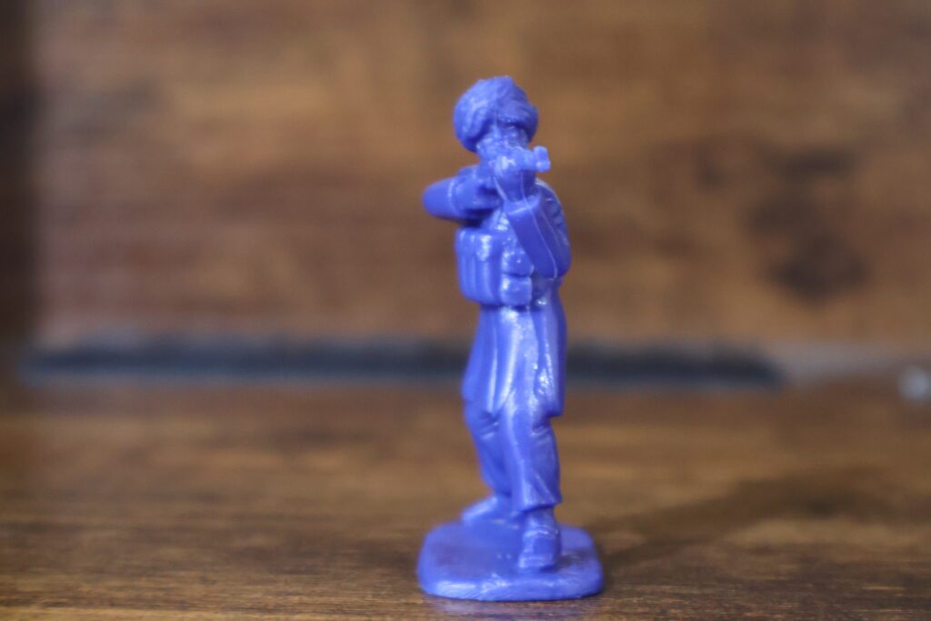 blue toy soldier aiming rifle